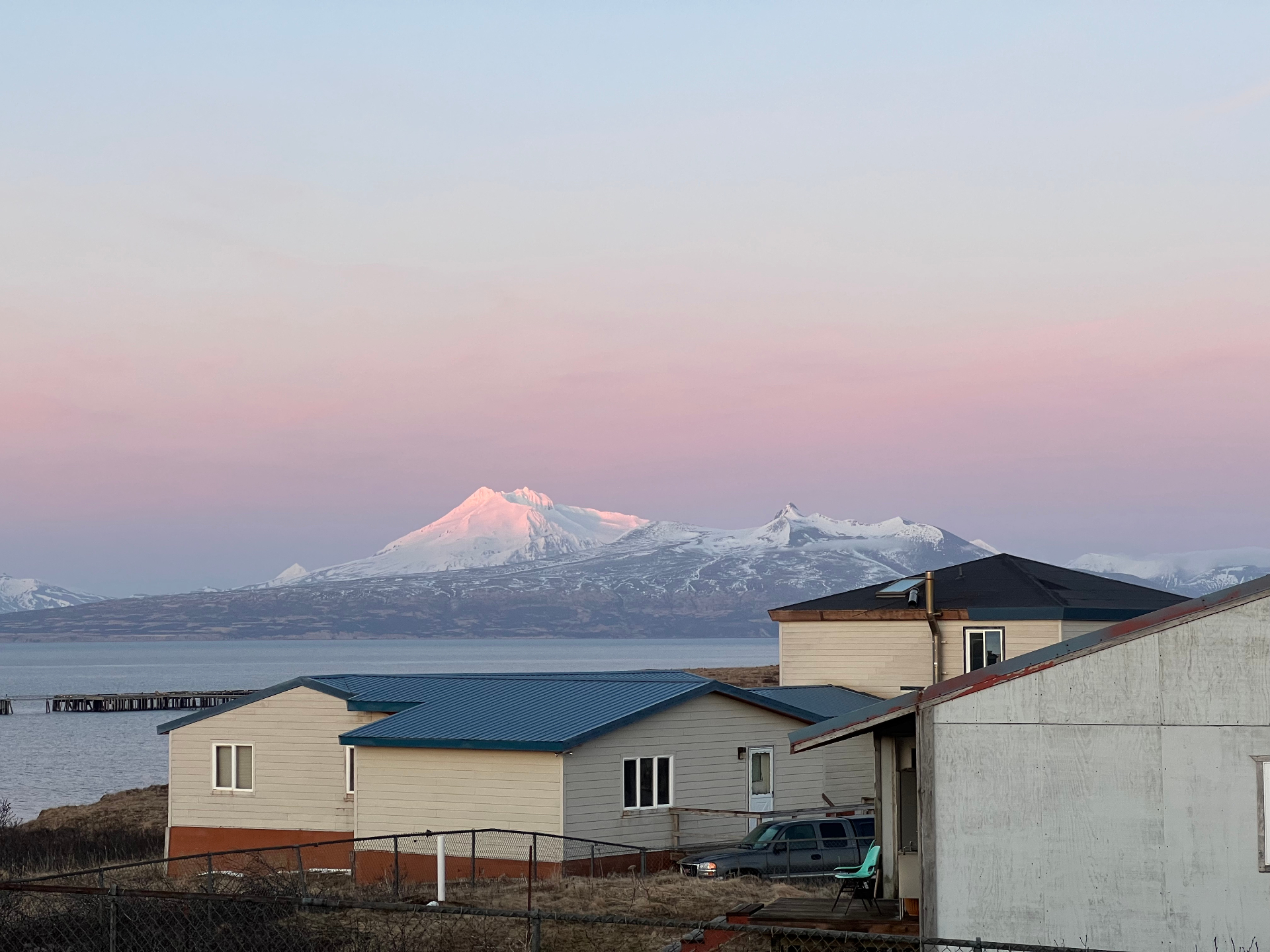 Cold Bay, Alaska at sunset with snow-capped mountains